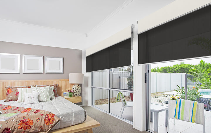 Dark Roller Dual blinds in bedroom with sliding doors